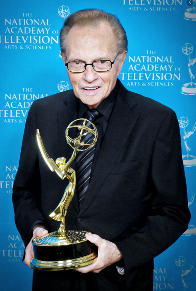 Larry King holding award