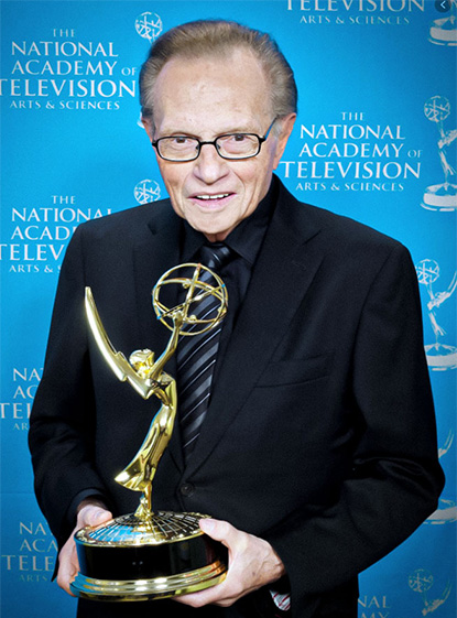 Larry King holding award