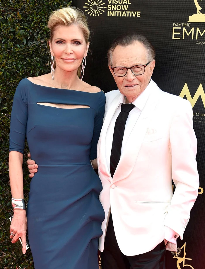 Larry King in white suit with wife Shawn Southwick in blue dress